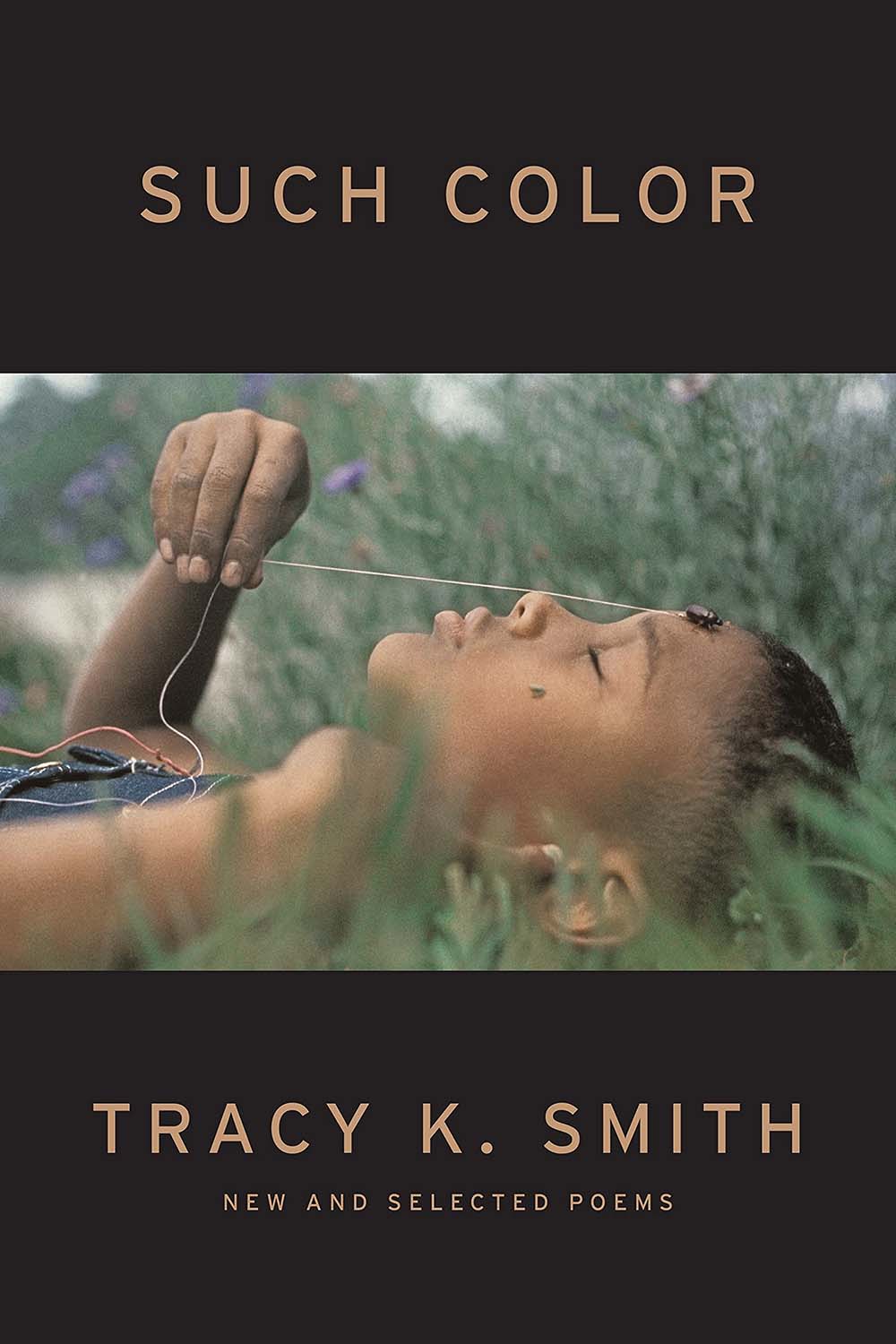 Such Color book cover, showing a young black girl laying in grass with her eyes closed peacefully, she is holding a piece of string attached to a beetle climbing on her forehead.