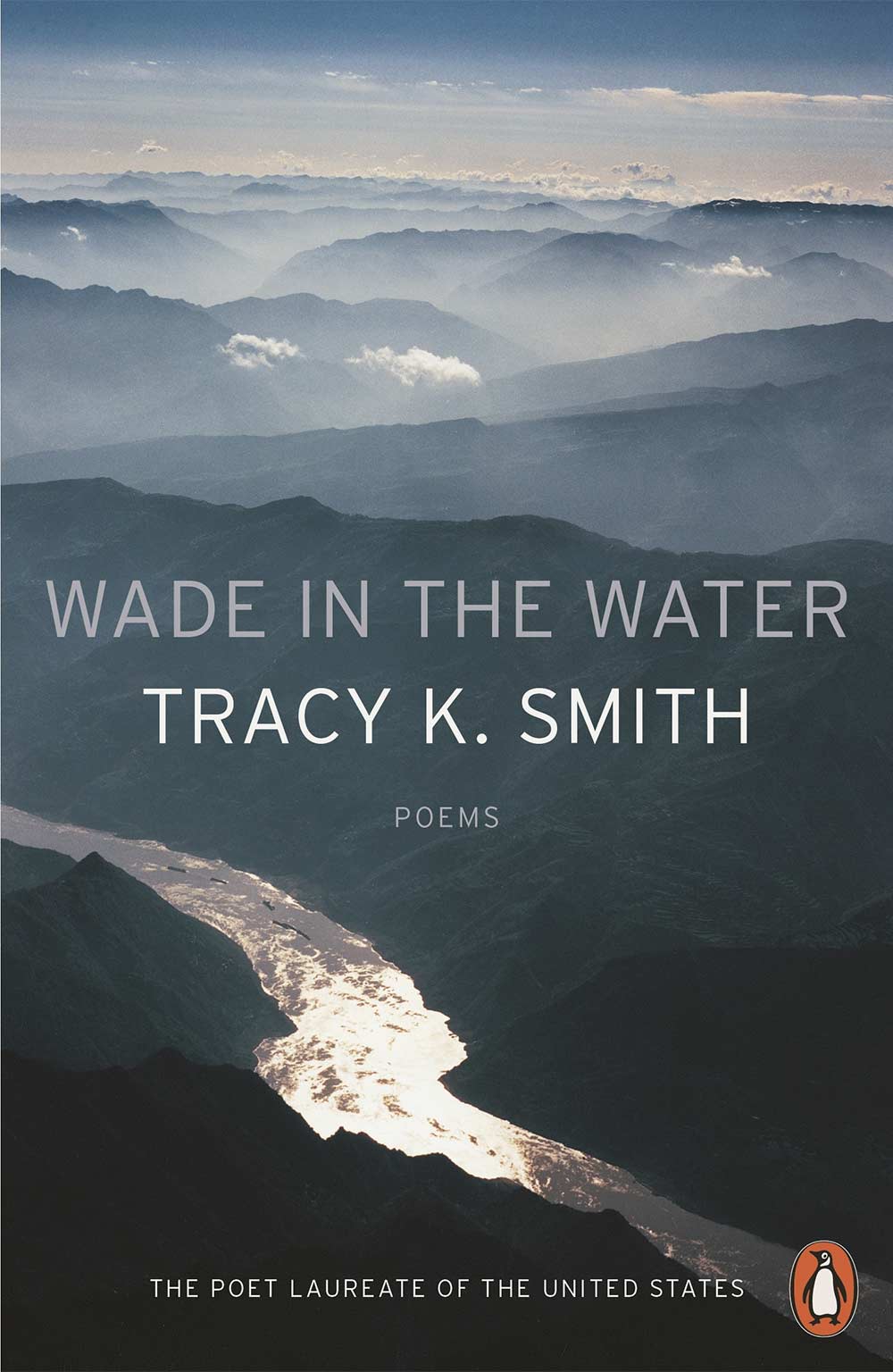 Wade in the Water book cover, featuring a river in the foreground and cloud covered mountains and sky in the background